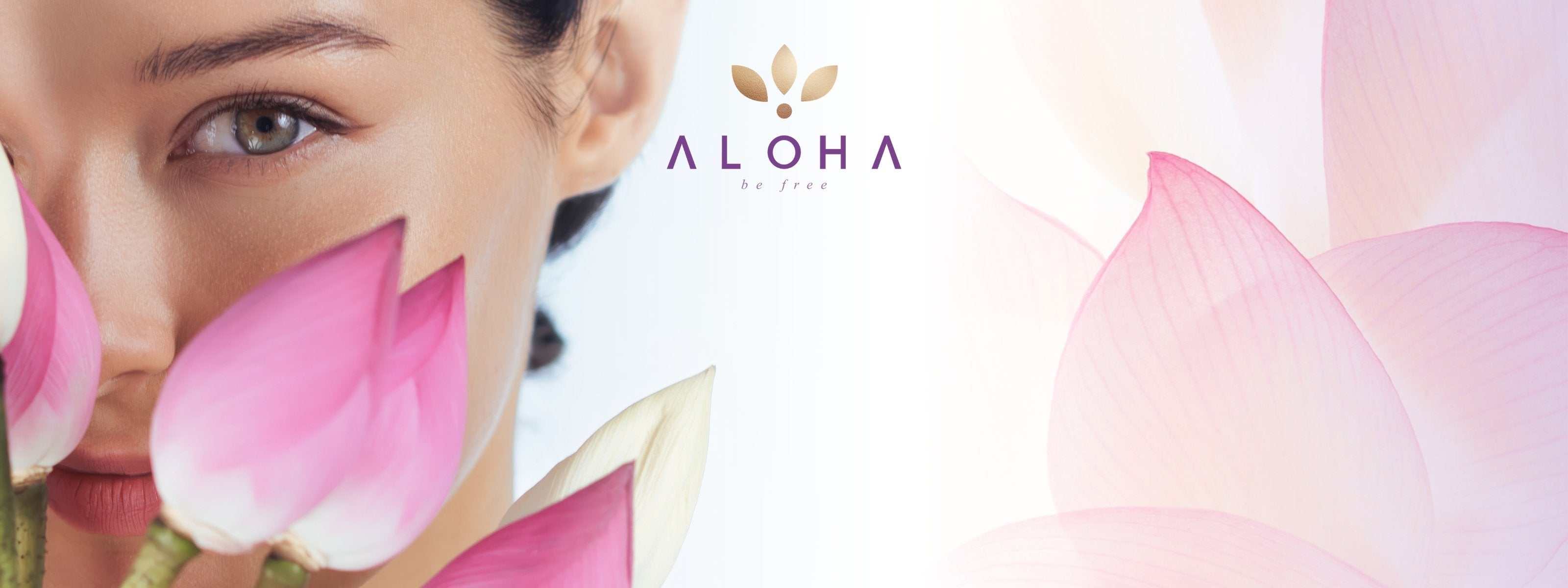 A woman’s captivating gaze peeks through delicate pink lotus petals, symbolizing purity, beauty, and spiritual awakening. Her flawless complexion and serene expression evoke a sense of natural elegance and inner harmony. The soft white background fades into translucent lotus petals, reinforcing a theme of gentle refinement. Above, the "Aloha" logo with golden leaves adds a touch of sophistication, embodying a philosophy of wellness, freedom, and self-care.