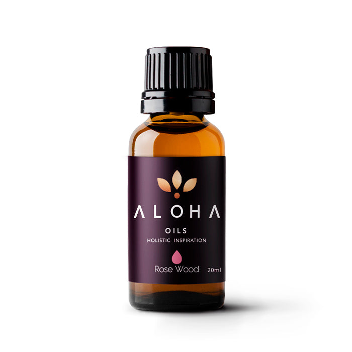 A 20ml amber glass bottle of Aloha Oils Rosewood essential oil with a sleek black cap and a modern purple label featuring the Aloha Oils logo and the tagline 'Holistic Inspiration.'